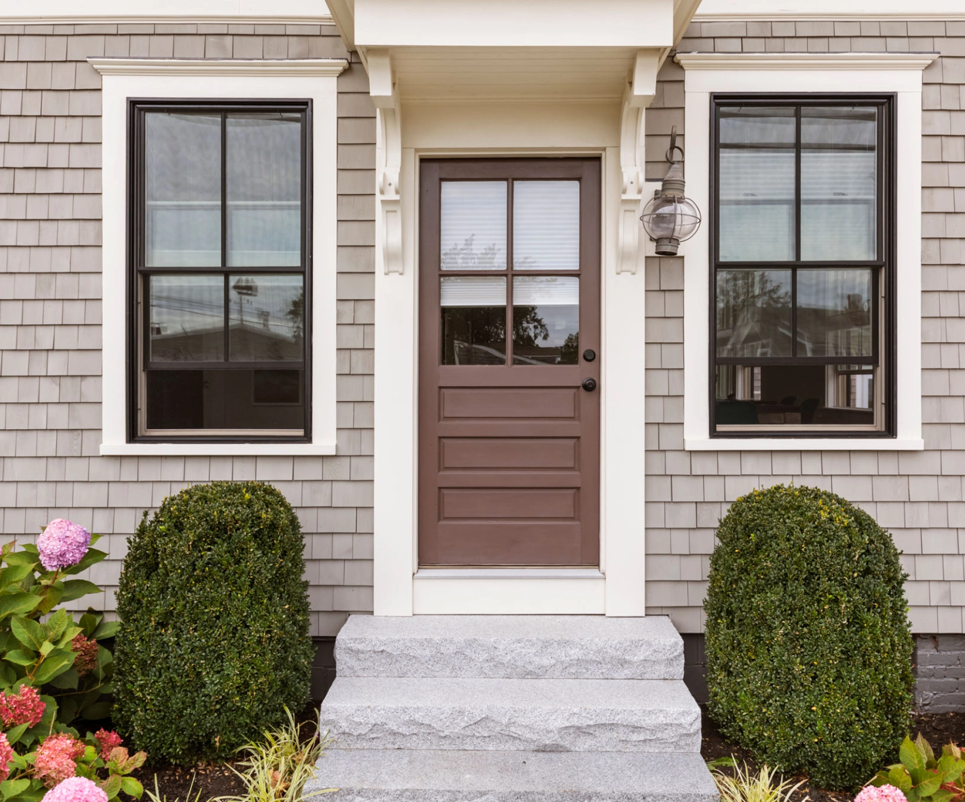House entrance with brown door and windows.