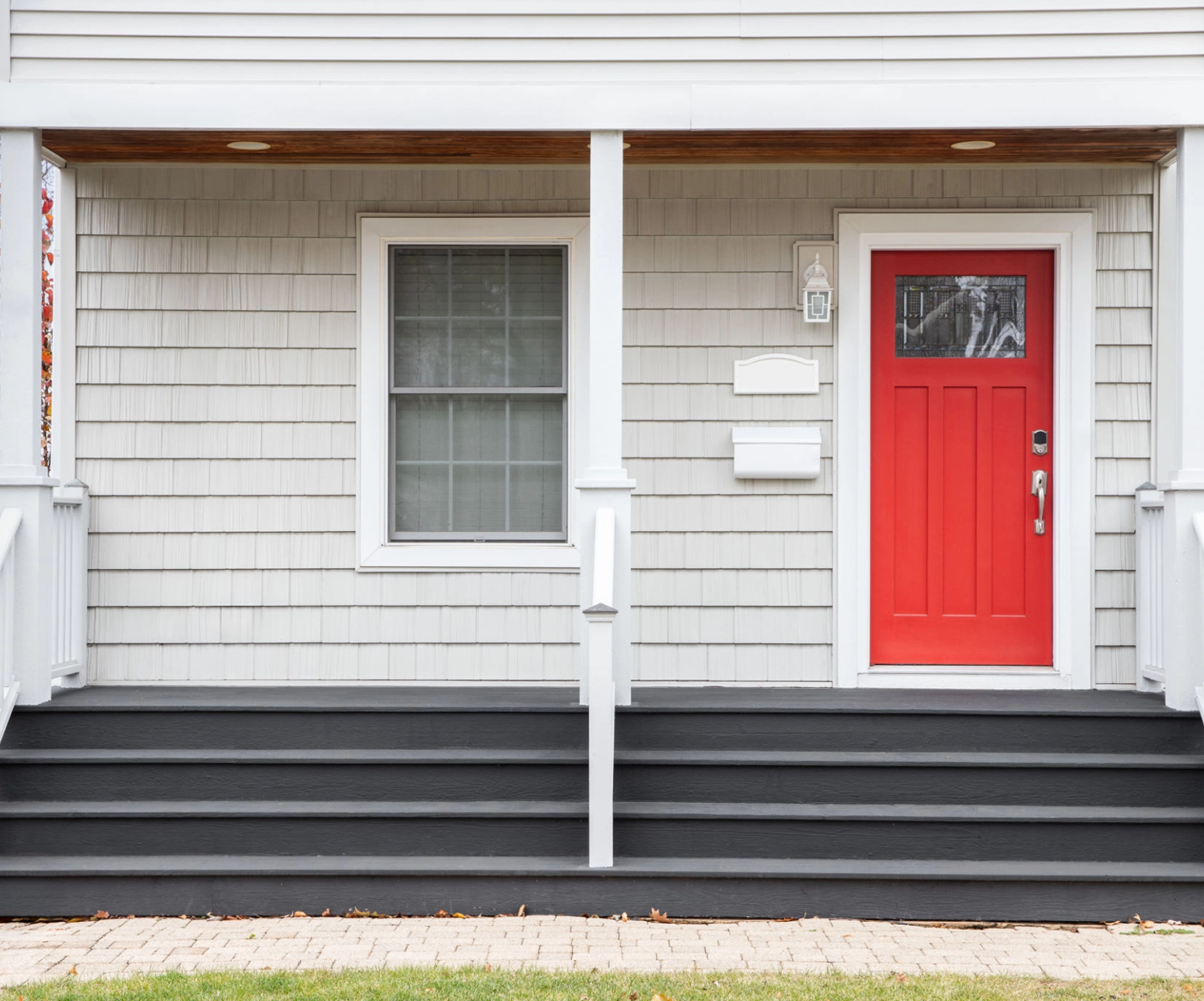 House entrance with red door and steps.